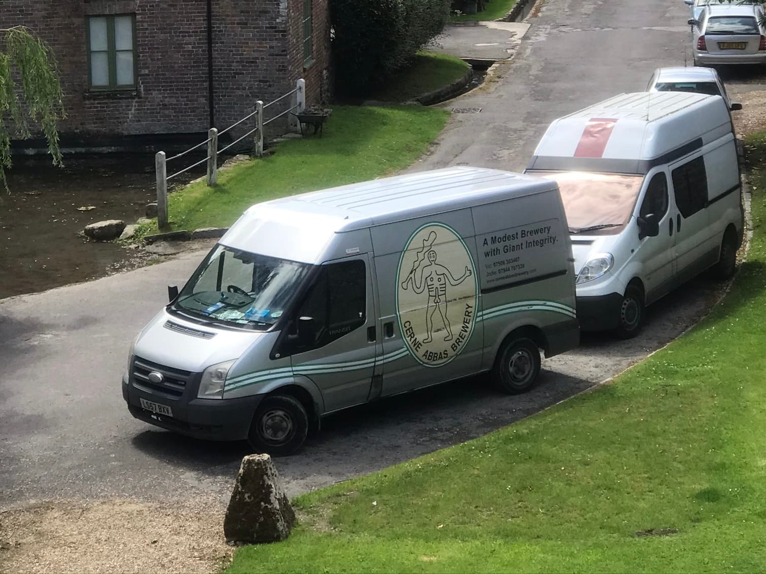 Cerne Abbas Brewery delivery vans by the millstream in Cerne Abbas